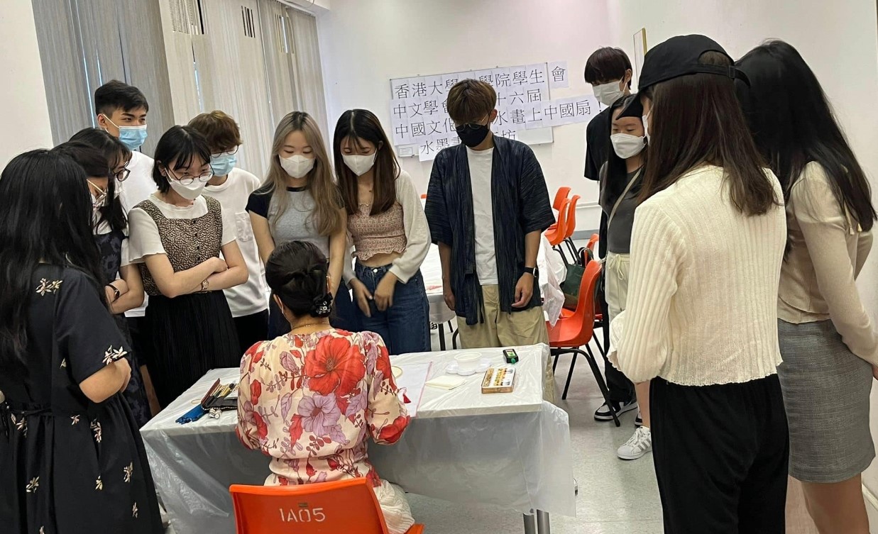 Students are participating in a Chinese Fan Ink Painting Workshop.