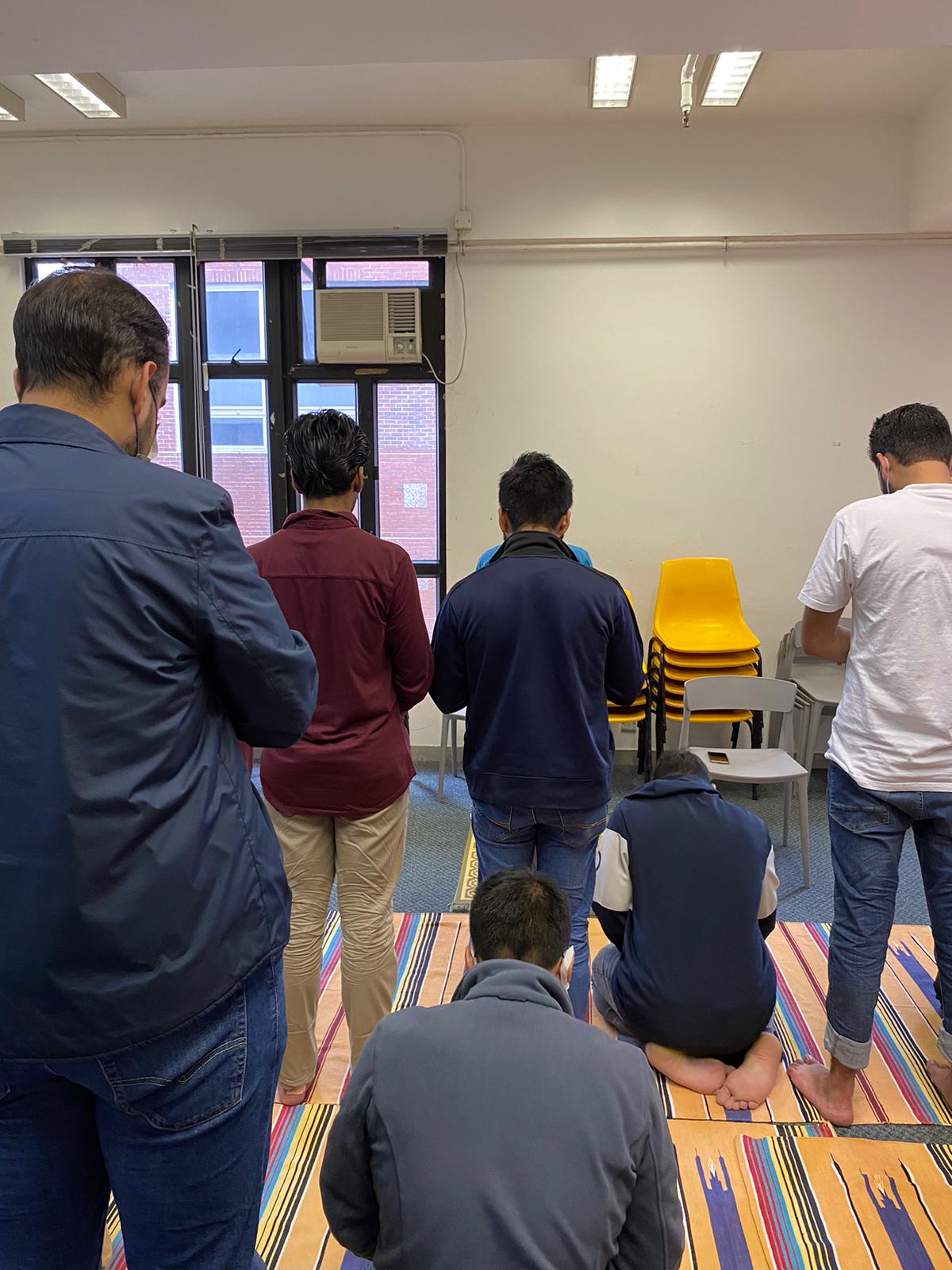 Students are participating in a weekly prayer session.